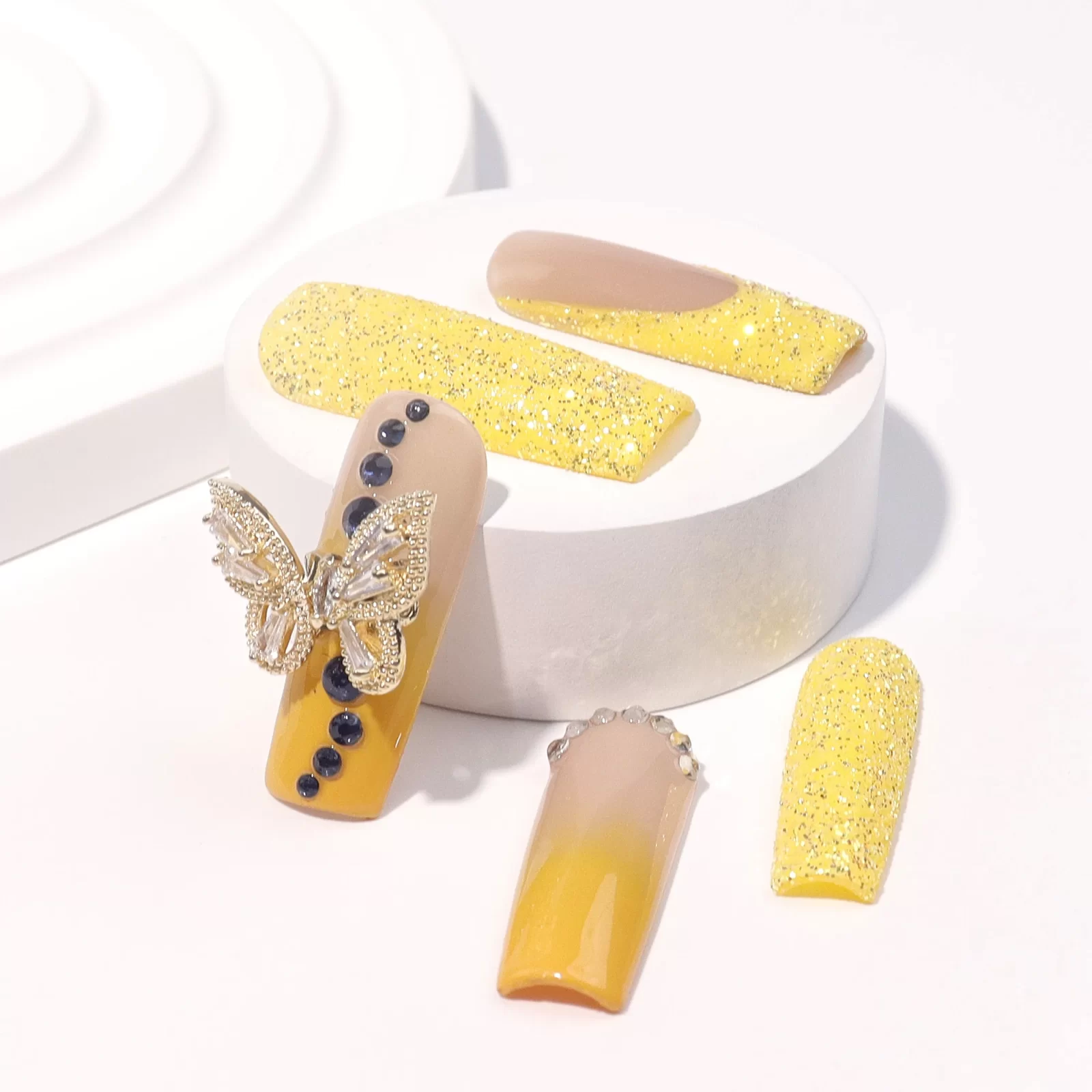 Yellow shiny press on nails with ombre and glitter jewelry embellishments